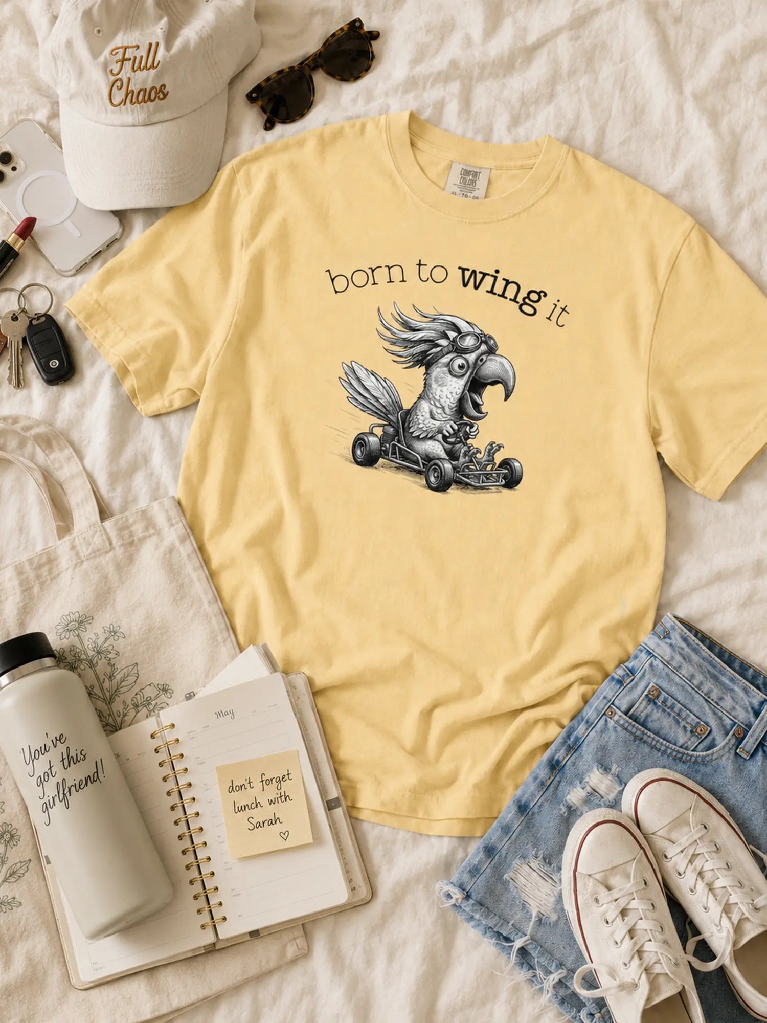 Born to Wing It cockatoo t-shirt in butter styled flat lay