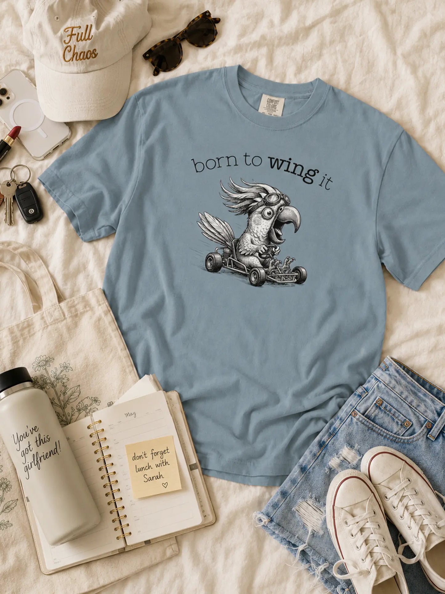 Born to Wing It cockatoo t-shirt in ice blue styled flat lay