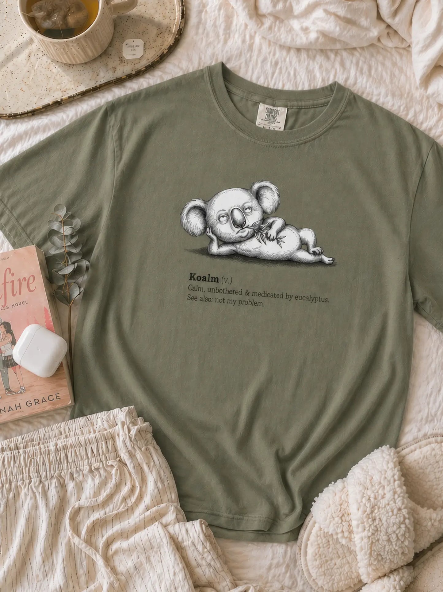 Faffle & Co Koalm Tee in moss styled flat lay