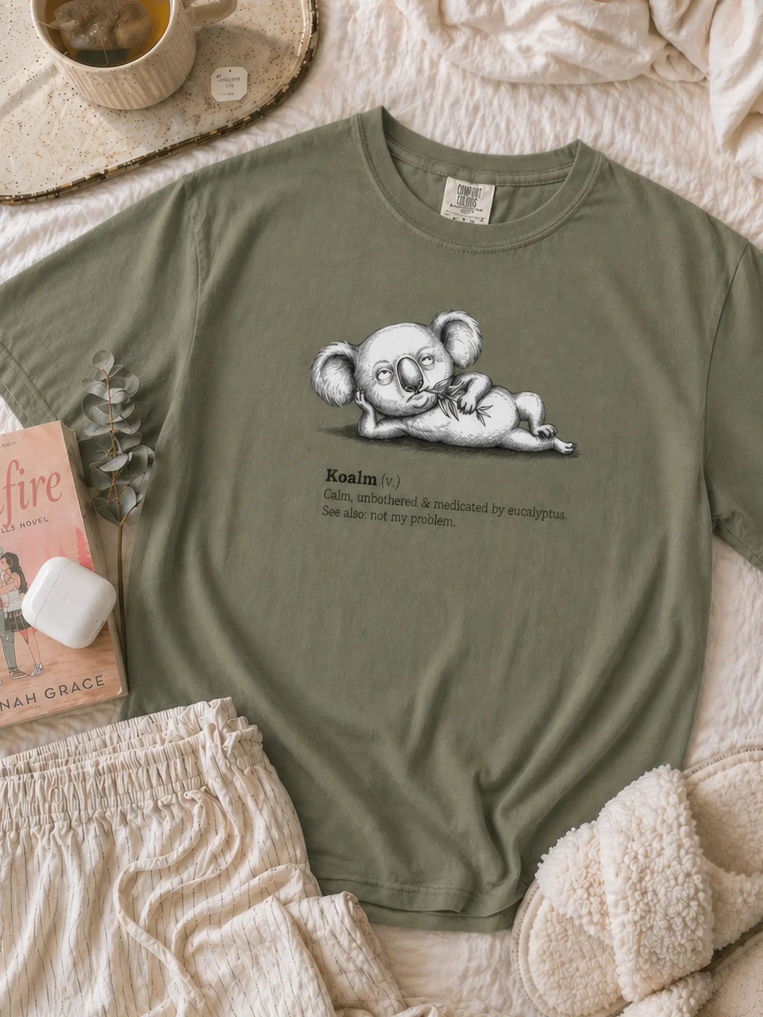 Faffle & Co Koalm Tee in moss styled flat lay