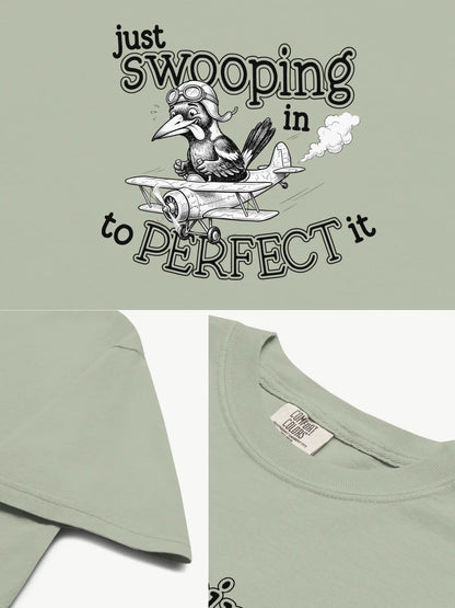 Close-up details of the Just Swooping In magpie t-shirt in bay showing print texture, folded view, and collar