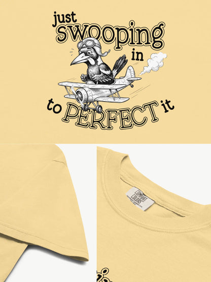 Close-up details of the Just Swooping In magpie t-shirt in butter showing print texture, folded view, and collar