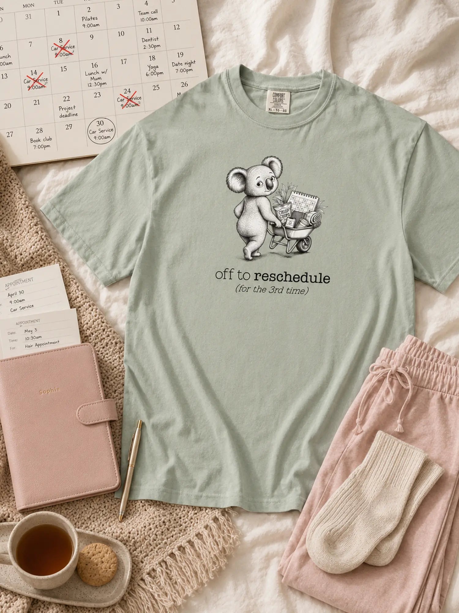 Off to Reschedule koala t-shirt in bay styled flat lay