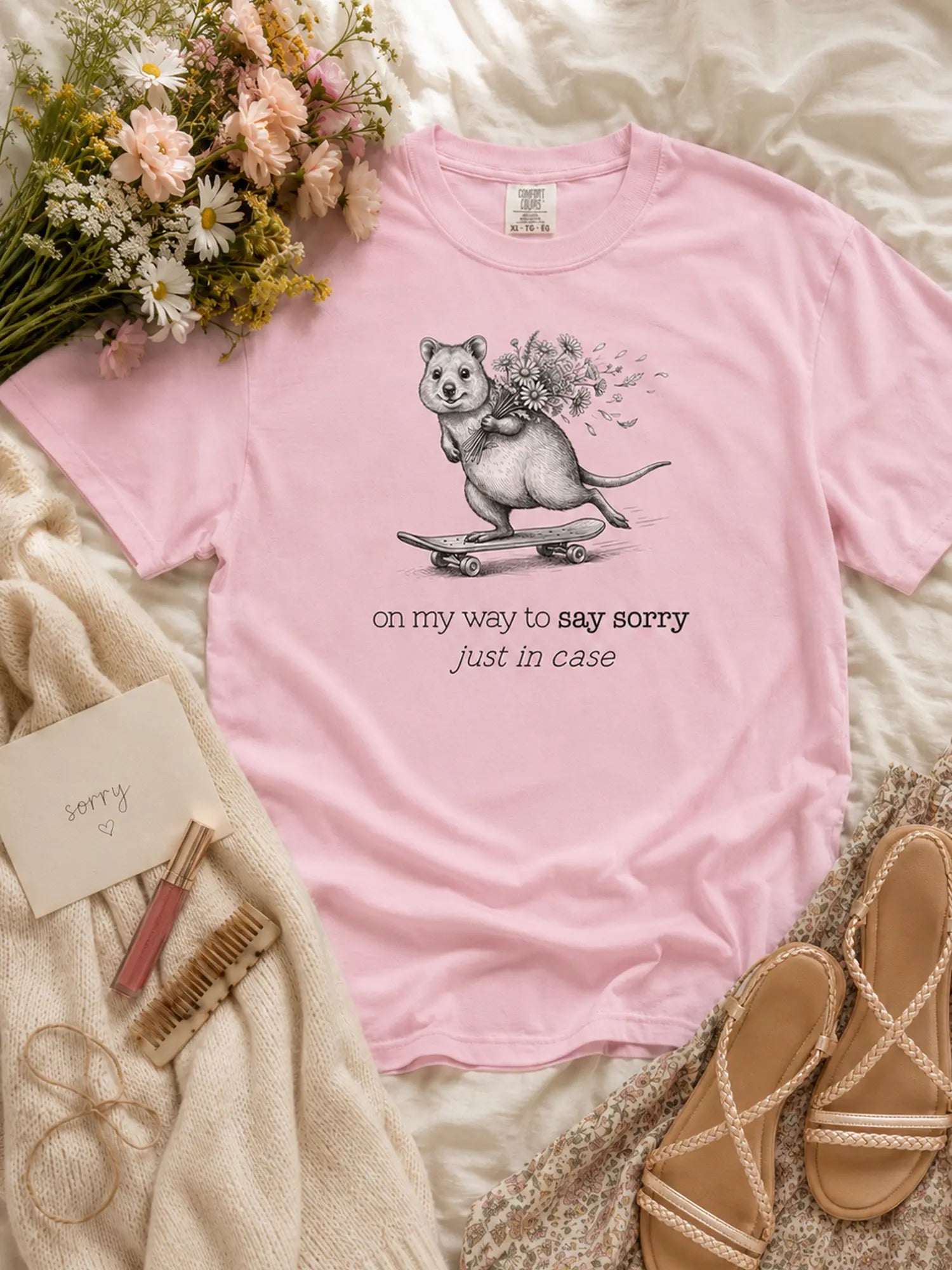 The Sorry Quokka t-shirt in blossom styled flat lay