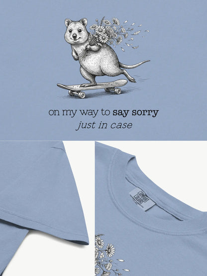 Close-up details of The Sorry Quokka t-shirt in washed denim showing print texture, folded view, and collar