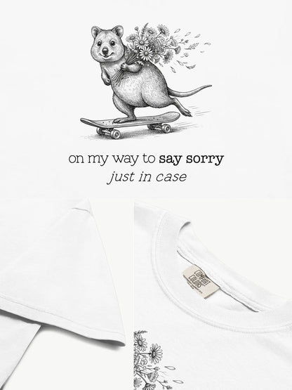 Close-up details of The Sorry Quokka t-shirt in white showing print texture, folded view, and collar