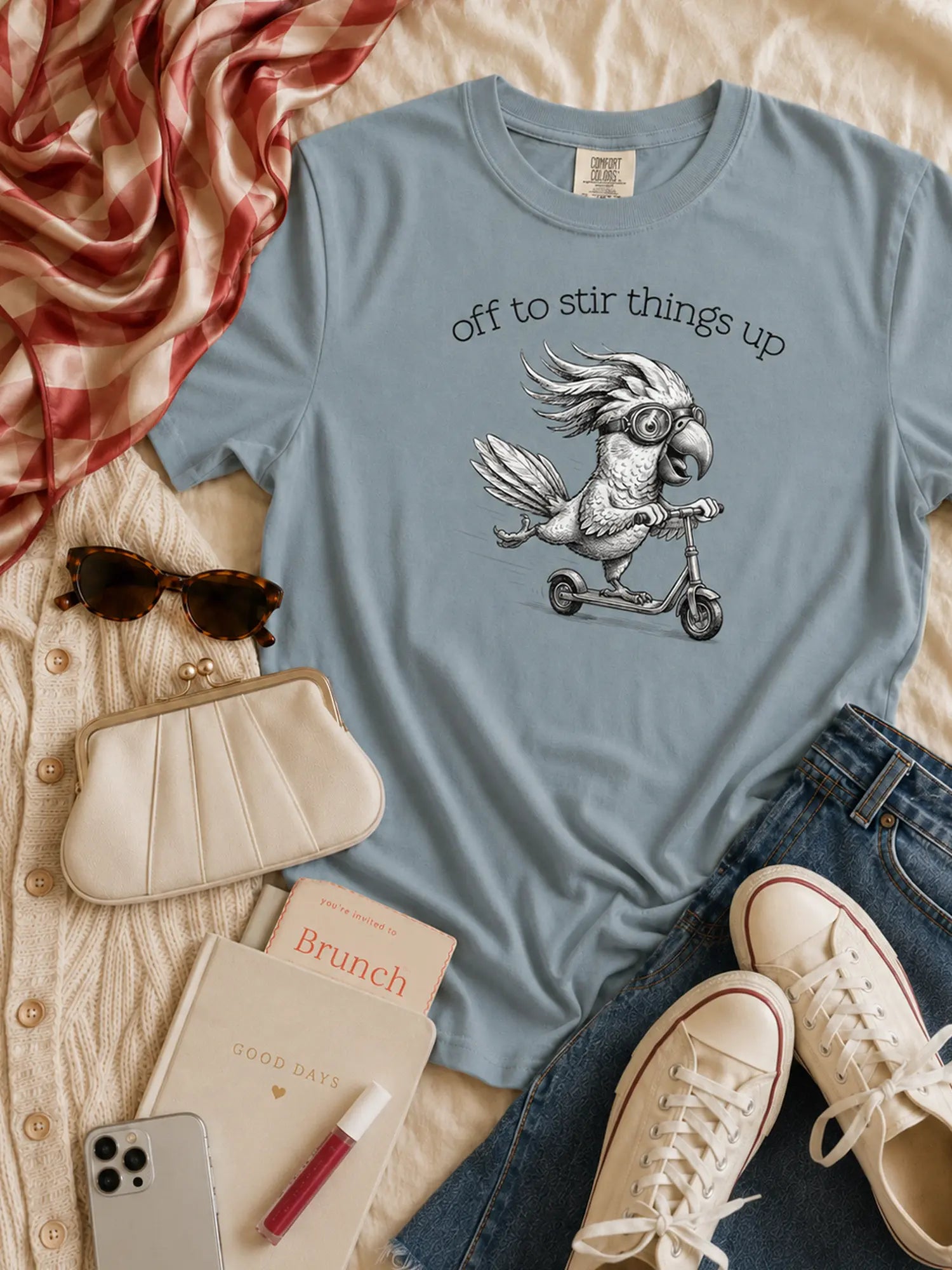 Off to Stir Things Up cockatoo t-shirt in ice blue styled flat lay