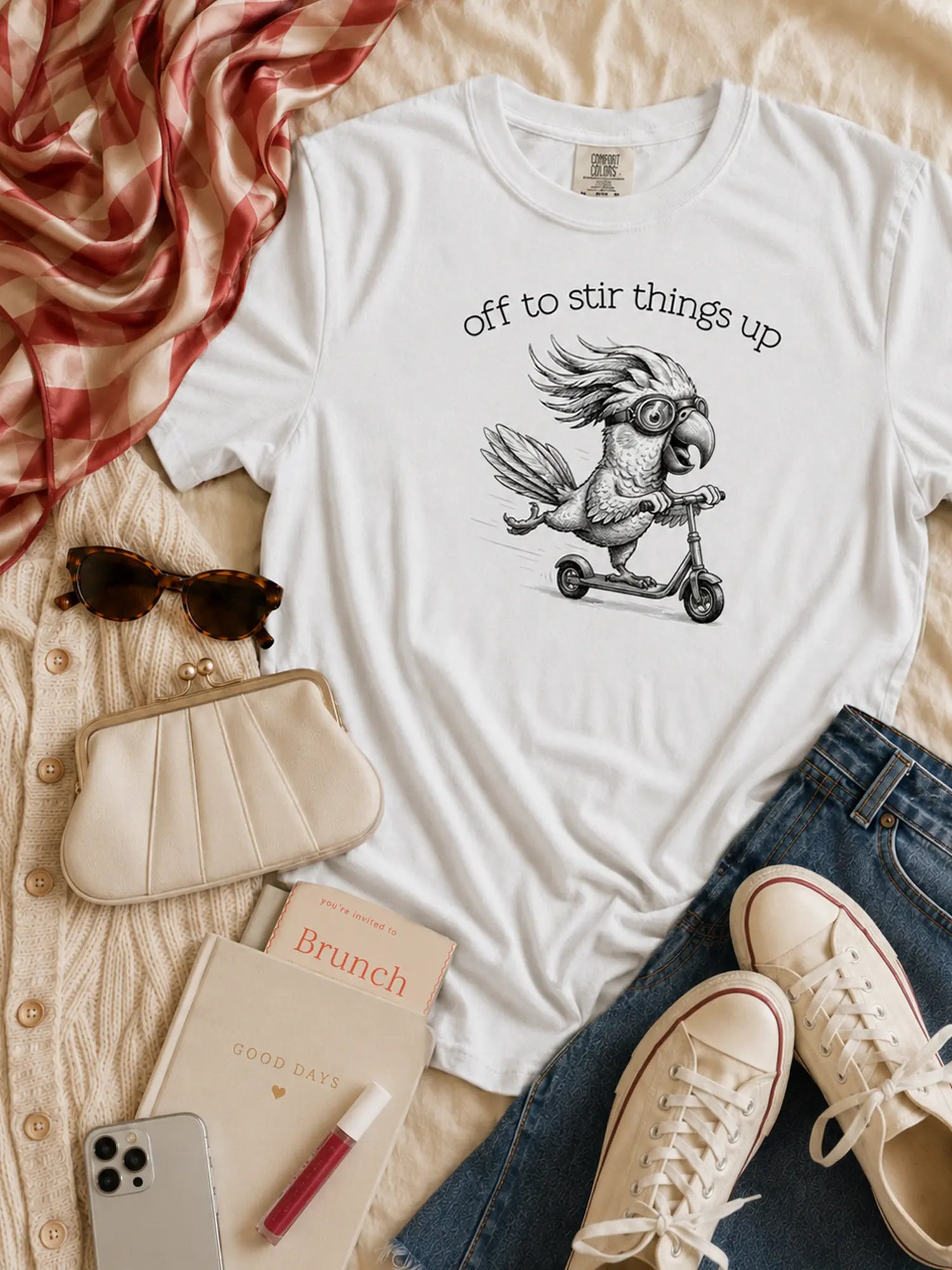 Off to Stir Things Up cockatoo t-shirt in white styled flat lay