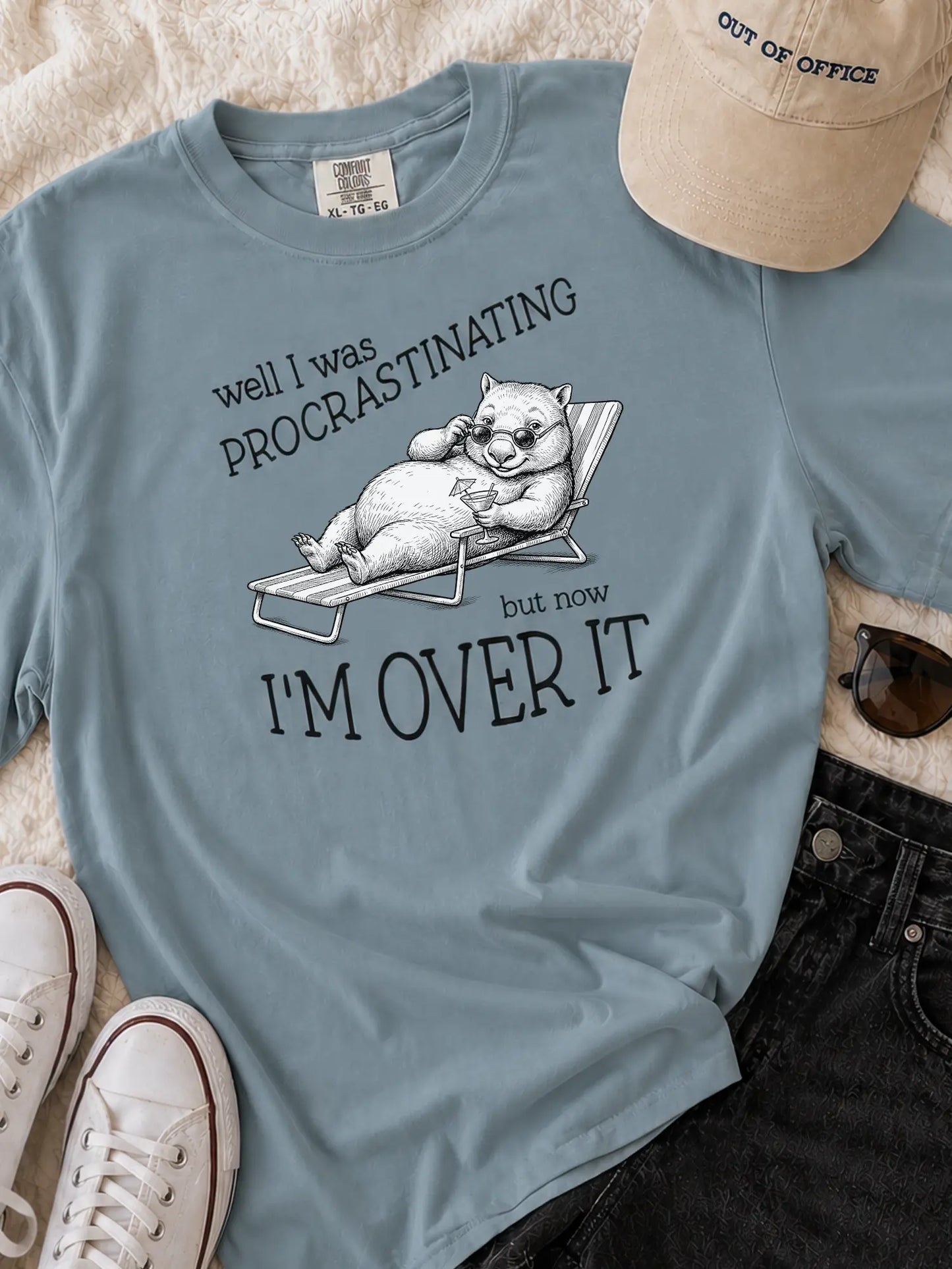 Faffle & Co Wombat Procrastinator Tee in ice blue styled flat lay