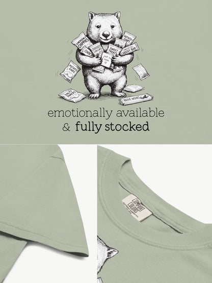 Close-up details of the Snack Support Wombat t-shirt in bay showing print texture, folded view, and collar
